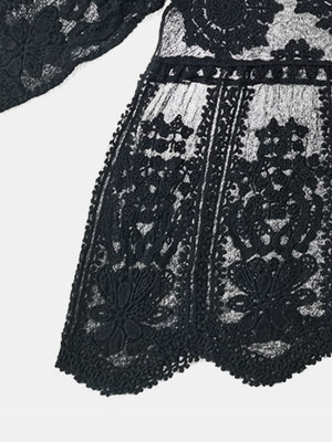 Black embroidered crochet kaftan cover-up with intricate floral details and scalloped hem.