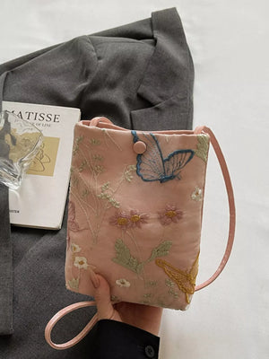 Pink embroidered mini crossbody bag with butterfly and floral details