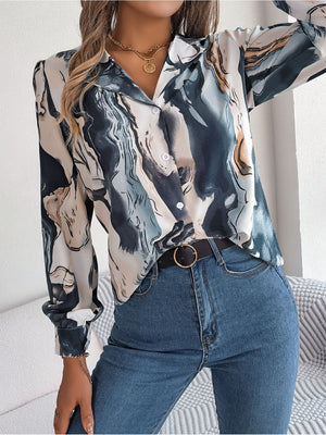 Women's abstract swirl print silk blouse in indigo with button front and collared neckline.