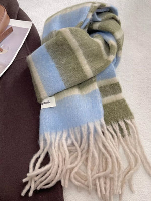 Plush striped scarf in blue, green, and cream with cream fringe.