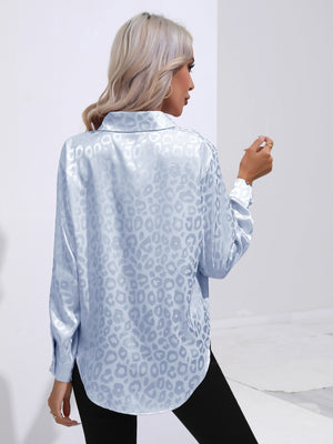 Light blue satin leopard print button-down shirt with a collared neckline and long sleeves.