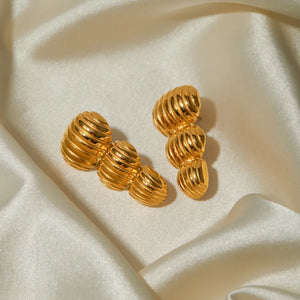Gold drop earrings with sculptural spiral design, 18K gold-plated.