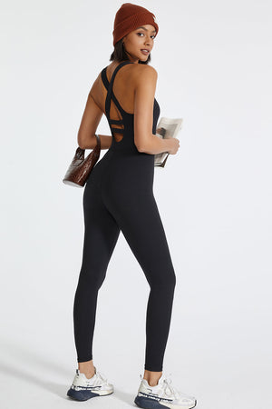 Black active jumpsuit with cross-back detail and full-length legs.