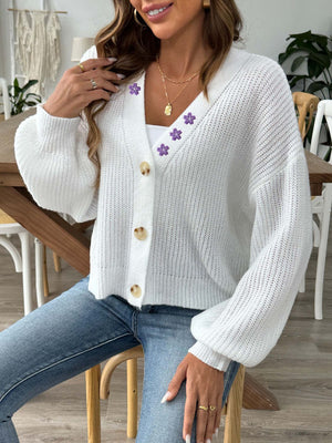 White balloon sleeve cardigan with floral embellishments and button front.