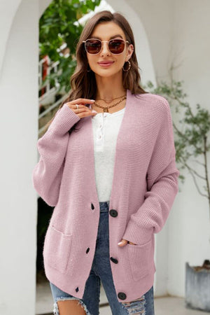 Blush pink textured knit cardigan with oversized pockets and button front.