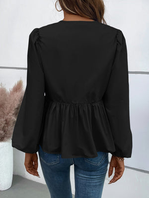 Black peplum blouse with gathered sleeves and a ruffled hem.