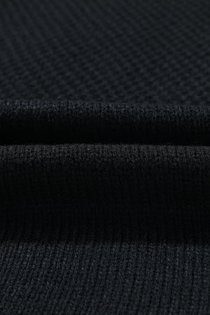 Black acrylic knit cardigan showing ribbed texture and fabric detail
