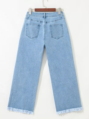 Medium wash denim cropped wide-leg jeans with frayed hem.