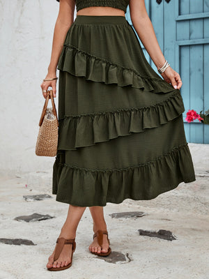Tiered midi skirt in dark green with ruffled tiers and textured fabric.