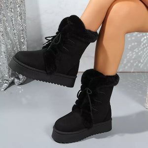 Black suede lace-up platform boots with faux fur trim and lug sole.