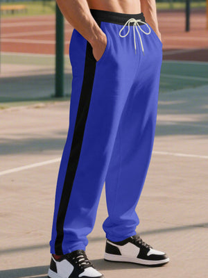 Men's royal blue sweatpants with black side stripe and drawstring waist.