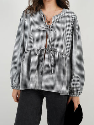 Tie-front peplum blouse with voluminous sleeves in black and white gingham.