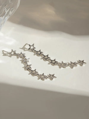 Silver celestial star dangle earrings with a delicate chain design.
