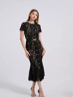 Black floral lace mermaid dress with short sleeves, pearl neckline, and embellished belt.