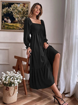 Black smocked midi dress with puff sleeves, square neckline, and tiered hem.