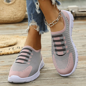Mesh slip-on sneakers in pink and gray with black stripe detail.