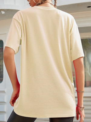 Oversized tan graphic tee with short sleeves and a relaxed fit.