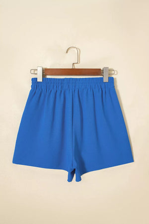 Blue drawstring shorts with elastic waistband and textured fabric.