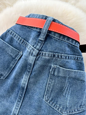 Patchwork denim midi skirt with red belt detail and contrast stitching.