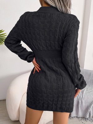 Black cable knit mini dress with long sleeves and sculpted fit