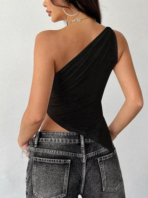 Black asymmetrical one-shoulder slim cami with draped detail, styled with jeans.