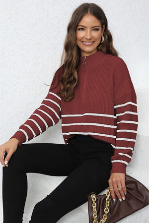 Burgundy ribbed knit quarter-zip sweater with white stripes on sleeves and body.