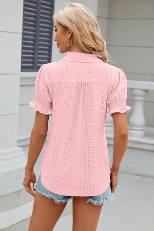 Blush pink eyelet polo blouse with short ruffled sleeves and a button-up back.