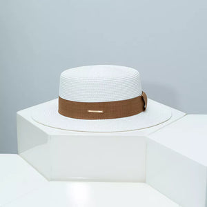 White woven straw boater hat with brown ribbon and gold accent