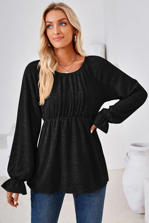 Black peasant blouse with elastic waist, gathered neckline, and ruffled bell sleeves.