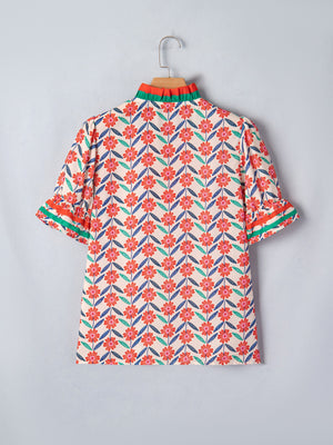 Blouse with allover floral print, ruffled neckline, and striped trim on sleeves.
