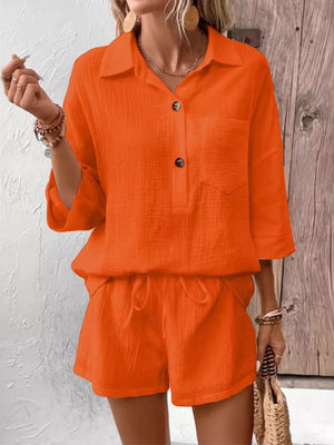 Orange-red cotton two-piece set with button-up shirt and drawstring shorts.