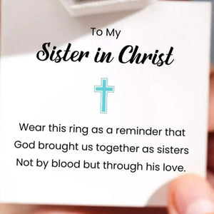 Intertwined cross sterling silver ring with blue zircon detail.