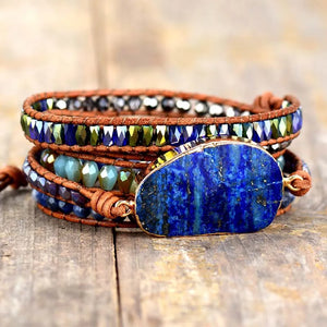 Lapis Lazuli wrap bracelet with blue beads and brown leather cord.