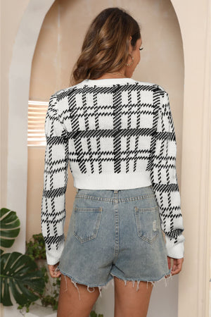 Plaid crop cardigan with puff shoulders in black and white acrylic, featuring button closure.