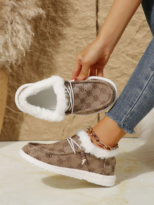 Taupe Southwestern print faux fur lined loafers with white laces and a gold chain ankle bracelet.