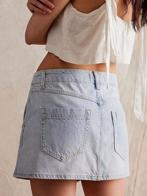 Light blue denim skort with asymmetrical button front and back pockets.