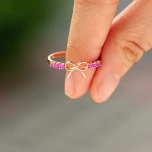 Rose gold ring with a bow and pink gemstones, 18K.