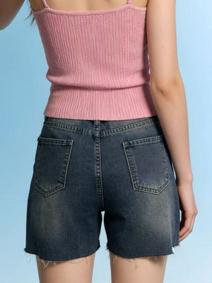 Denim shorts with frayed hem and distressed details.