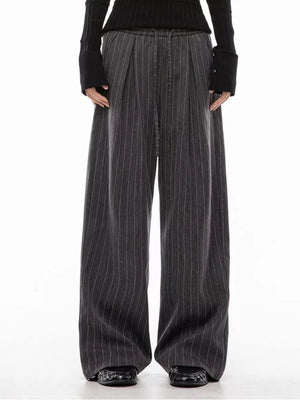 Men's dark grey pinstripe wide-leg pleated trousers with drawstring waist.