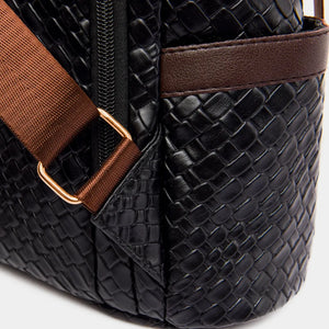 Black woven faux leather convertible backpack with brown strap detail.