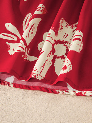 Red floral print blouse with bow tie detail, showing fabric texture and hem.