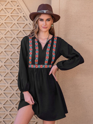 Black mini dress with embroidered yoke and long sleeves