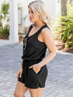 Black button-front drawstring waist romper with V-neck and pockets