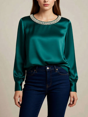 Green satin blouse with pearl trim round neckline and long sleeves.