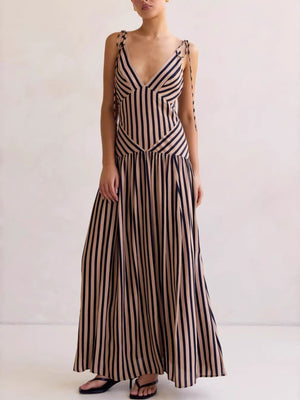 Tie-shoulder maxi dress with V-neck in brown and navy stripes, featuring adjustable straps and a flowing skirt.