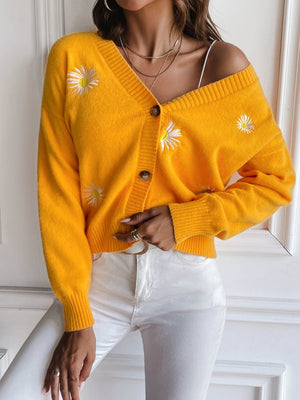 Gold button-down cardigan with daisy embroidery and V-neck.