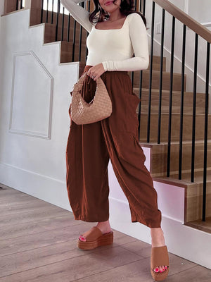 Linen balloon trousers in dark brown with cargo pockets and a relaxed fit.