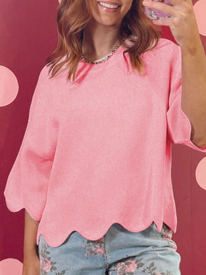Pink knit sweater with scalloped hem and sleeves