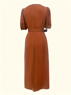 Belted midi dress in rust with puff sleeves and a-line cut.