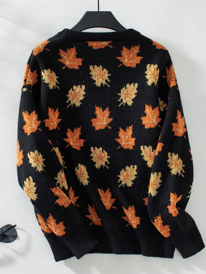 Black knit jumper with orange and yellow autumnal leaf pattern, crew neck, long sleeves.